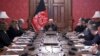 FILE - In this photo released by the Afghan Presidential Palace, Afghan President Ashraf Ghani, center, speaks to U.S. peace envoy Zalmay Khalilzad, third left, at the presidential palace in Kabul, Afghanistan, Jan. 28, 2019. 