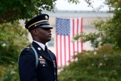 FILE - A member of the U.S. Army Old Guard stands on the grounds of the National 9/11 Pentagon Memorial before a ceremony in observance of the 18th anniversary of the Sept. 11, 2001, attacks at the Pentagon in Washington, Sept. 11, 2019.