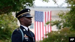 A member of the U.S. Army Old Guard stands on the grounds of the National 9/11 Pentagon Memorial before a ceremony in observance of the 18th anniversary of the Sept. 11, 2001, attacks at the Pentagon in Washington, Sept. 11, 2019.
