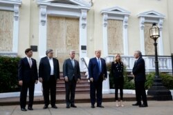 President Donald Trump stands outside St. John's Church, June 1, 2020, in Washington. Standing with Trump are Mark Esper, from left, William Barr, Robert O'Brien, Kayleigh McEnany and Mark Meadows.