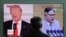 FILE - A man watches a TV screen showing file footages of U.S. President Donald Trump (L) and North Korean leader Kim Jong Un (R) during a news program at the Seoul Railway Station in Seoul, South Korea, March 27, 2018. 