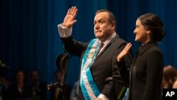 FILE - Alejandro Giammattei waves to the crowd accompanied by his daughter Ana Marcela after he was sworn-in as president of Guatemala at the National Theater in Guatemala City, Jan. 14, 2020. 