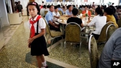 A young North Korean student waits in the dining hall of the Ongnyugwan, a popular noodle restaurant, Sept. 1, 2014 in Pyongyang