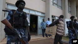 Togolese police forces stand guard at gate as electoral Commission members arrives with the ballot result papers on March 6, 2010 in Lome ahead of an election results announcement.