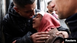 A Palestinian injured in an Israeli strike mourns the death of her sibling in the strike, at Abu Yousef Al-Najjar hospital in Rafah in the southern Gaza Strip on Feb. 23, 2024.