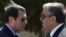 FILE - Cypriot President Nicos Anastasiades, left, and breakaway Turkish Cypriot leader Mustafa Akinci, right, talk at the disused Nicosia airport inside a United Nations controlled buffer zone in this divided island of Cyprus, Sept. 14 2016. 