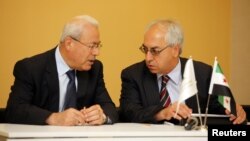 The new president of the Syrian National Council Abdelbaset Seida (R) talks with former President Burhan Ghalioun before a news conference in Istanbul, June 10, 2012.