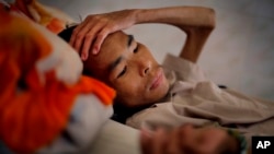  FILE - A patient in the advanced stages of AIDS, lays in his bed at the Mai Hoa Center for HIV and AIDS patients in the village of An Nhon Tay, 60 kilometers, (37 miles) northwest of Ho Chi Minh City, Vietnam, Oct. 10, 2009.