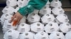 FILE - Masks are seen on a production line manufacturing masks at a factory in Shanghai, China January 31, 2020.