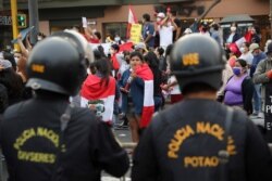 People celebrate in the street after Peru's new interim President Francisco Sagasti was designated by Congress to lead the nation, in Lima, Peru, Nov. 16, 2020.