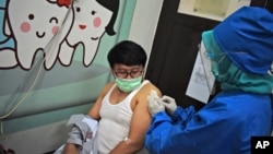 Seorang tenaga medis menyuntikan vaksin virus corona kepada seorang relawan dalam uji klinis vaksin di Bandung, Jawa Barat, 14 Agustus 2020. 