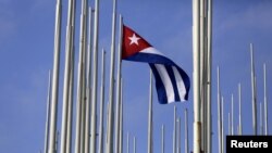 FILE - The Cuban flag flies in front of the U.S. Interests Section in Havana, May 22, 2015. 