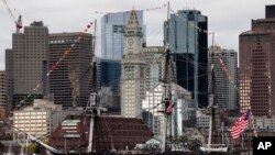 The USS Constitution moves past the skyline in Boston, Oct. 18, 2019. 