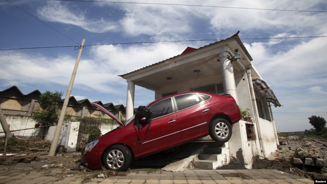 A car damaged by floods is seen after heavy rainfalls hit Zhou Kou Dian Village, Fangshan district, near Beijing, China, July 22, 2012. 