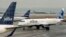 A JetBlue airplane taxis to a gate at Boston's Logan Airport, Jan. 6, 2014.
