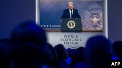 U.S. President Donald Trump is seen on a large screen during his address by video conference at the World Economic Forum annual meeting in Davos, Switzerland, Jan. 23, 2025.