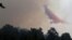 Fire retardant is dropped on a huge forest fire that continues to rage out of control for a third day, in the mountainous areas southwest of Cyprus' capital Nicosia, June 21, 2016. 