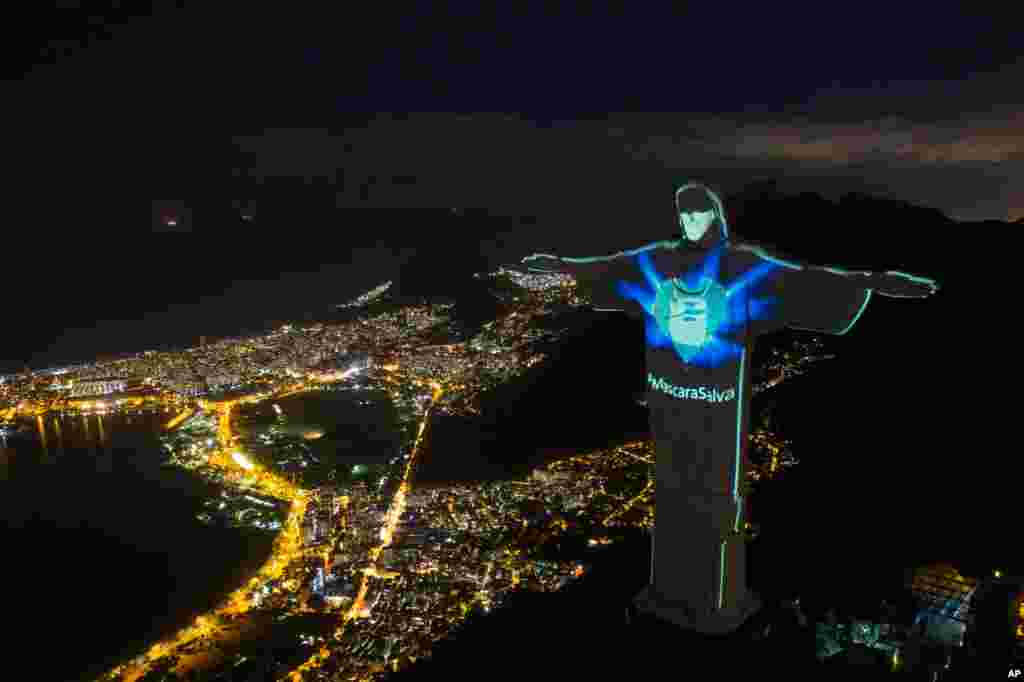 Rio's Christ the Redeemer statue is lit up as if wearing a protective mask in Rio de Janeiro, Brazil, May 3, 2020.