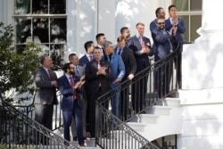 Members of the Washington Nationals gather during an event with President Donald Trump to honor the 2019 World Series champion Nationals baseball team at the White House, Nov. 4, 2019, in Washington.