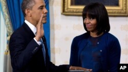 President Obama takes the oath of office at the official swearing-in ceremony in the Blue Room of the White House, January 20, 2013. 