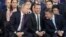 President Vladimir Putin, foreground left, speaks to Russian Prime Minister Dmitry Medvedev, center, and acting Secretary of the General Council of United Russia Andrey Turchak , right, at the United Russia party congress in Moscow, Russia, Dec. 23, 2017.