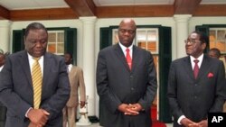 Zimbabwean Prime Minster, Morgan Tsvangirai, left, his deputy Arthur Mutambara and President Robert Mugabe walk together after their end of year press conference at State House in Harare, 20 Dec. 2010