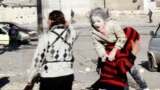 A man carries a wounded girl who survived what activists say was an air strike by forces loyal to Syrian President Bashar al-Assad in Aleppo&#39;s al-Ansari al-Sharqi neighborhood. 