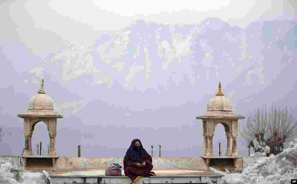 A Kashmiri Muslim woman prays outside Hazratbal Shrine after special prayers on the death anniversary of Abu Bakr Siddiq, the first Caliph of Islam, at Hazratbal Shrine in Srinagar, Indian-controlled Kashmir.