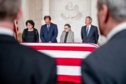From left, Associate Justices Sonia Sotomayor, Samuel Alito, Ruth Bader Ginsburg and Chief Justice John Roberts stand before the casket of the late Supreme Court Justice John Paul Stevens at the Supreme Court, July 22, 2019.