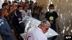 以色列近日发动空袭时炸死的七名美国援助组织“世界中央厨房”工作人员其中一人的尸体从加沙地带拉法的一家医院太平间运出。（2024年4月3日）