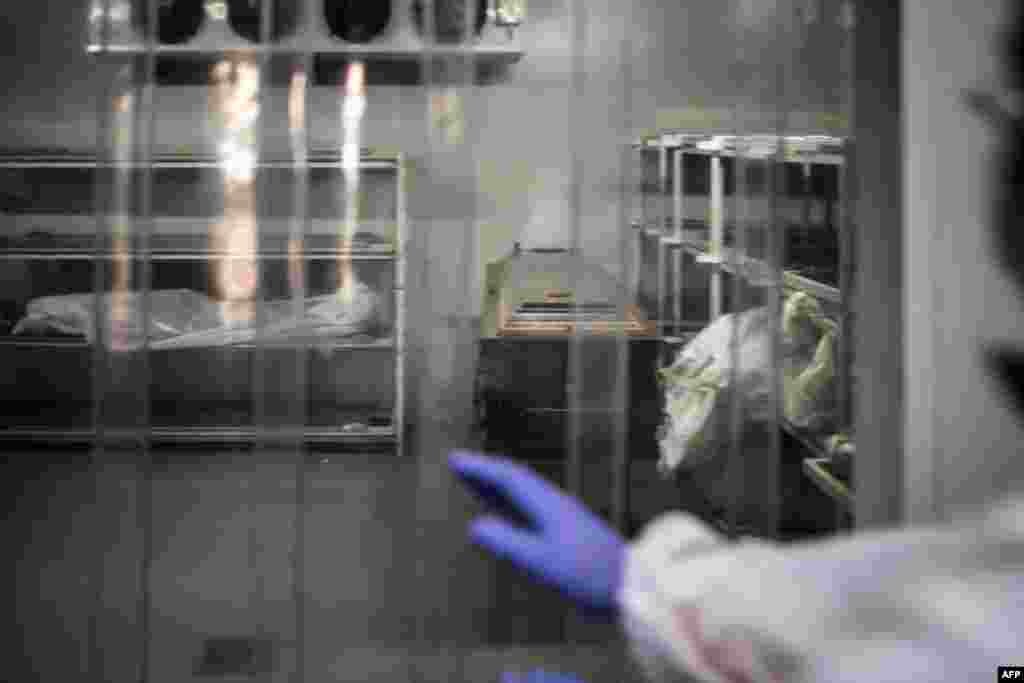 An undertaker approaches a cold storage room where remains of COVID-19 patients are stored at the AVBOB mortuary in Soweto, South Africa.