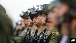 FILE - Belarusian and Russian troops take part in the Zapad (West) 2017 Russia-Belarus military exercises at the Borisovsky range in Borisov, Belarus, Wednesday, Sept. 20, 2017. (AP Photo/Sergei Grits)