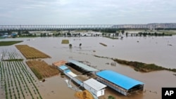 FILE - In this photo released by Xinhua News Agency, an aerial photo shows an overflowing Yellow River near the Lianbo Village in Hejin City, northern China's Shanxi Province, Oct. 10, 2021.