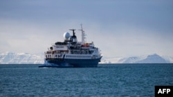 FILE - A boat with tourists onboard leaves Longyearbyen, located on Spitsbergen island, in Svalbard Archipelago, northern Norway, on May 16, 2024.