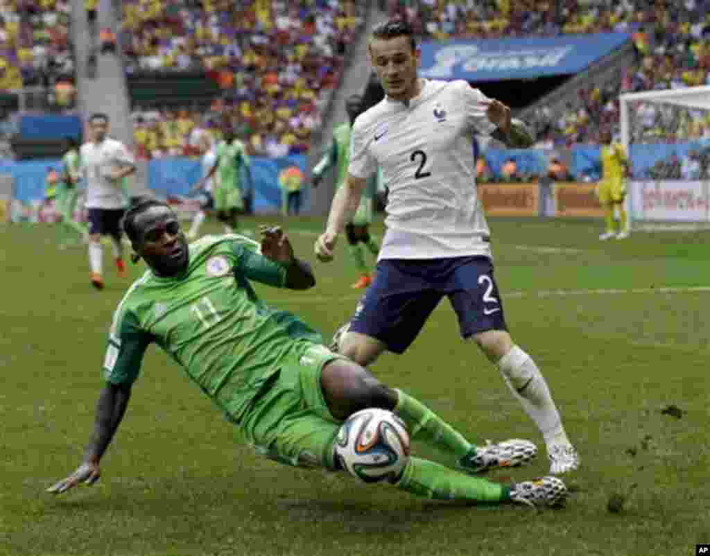 France's Mathieu Debuchy, right, and Nigeria's Victor Moses fight for the ball during the World Cup round of 16 soccer match between France and Nigeria at the Estadio Nacional in Brasilia, Brazil, Monday, June 30, 2014. (AP Photo/Ricardo Mazalan)