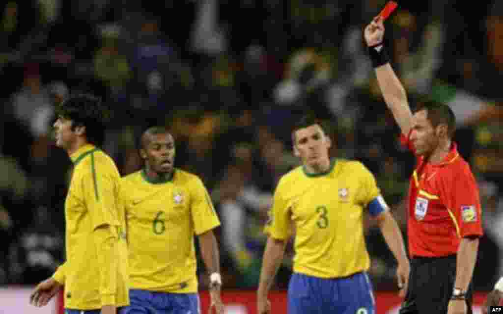 Referee Stephane Lannoy, of France, right, shows a red card to Brazil's Kaka, left, during the World Cup group G soccer match between Brazil and Ivory Coast at Soccer City in Johannesburg, South Africa, Sunday, June 20, 2010. (AP Photo/Ivan Sekretarev)