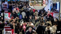 FILE - In New York, people fought for parking spots and battled crowds to shop at Macy's department store during the Christmas holiday season, Nov. 29, 2019. (AP Photo/Bebeto Matthews)