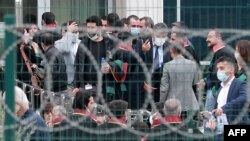 Lawyers, who were not allowed inside, wait outside the Sincan Penal Institutions Campus as the trials begin for pro-Kurdish Peoples' Democratic Party (HDP) members for their alleged roles in deadly 2014 protests on April 26, 2021.