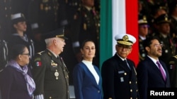 FILE - Mexico's Defense Minister Ricardo Trevilla Trejo and Secretary of the Navy Raymundo Pedro Morales Angeles stand next to Mexico's President Claudia Sheinbaum during a ceremony in Mexico City, Mexico, October 3, 2024. 