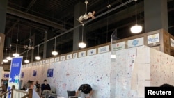 People sit inside a COVID-19 vaccination site attached to New York Mets stadium Citi Field, in Queens, New York, May 24, 2021.