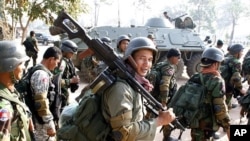 Cambodian soldiers carry their weapons near Preah Vihear temple along the border with Thailand, file photo. 