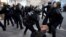 Riot Police officers apprehend a protester during clashes at a demonstration against alleged police abuse, in Paris where anti-racism groups and other activists gathered in support of victims of police violence. 