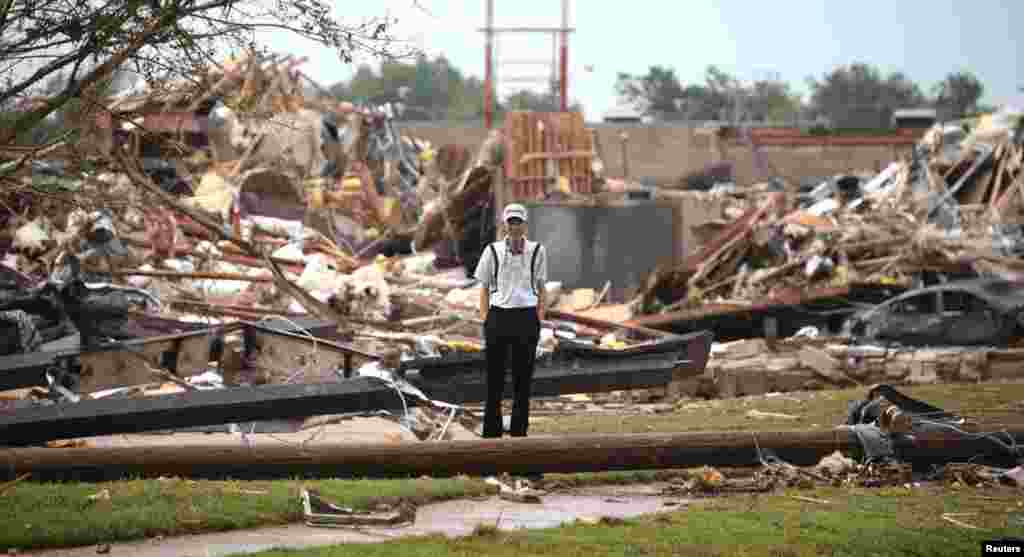 A man stands among the wreckage in Moore, Oklahoma, May 20, 2013