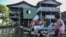 Women wash clothes at the Amazon river in Leticia, Colombia, on May 13, 2020, amid the new coronavirus pandemic. 