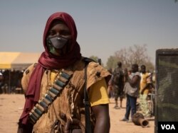 A member of a civilian militia looks on at a rally in Zagtouli, to celebrate the organization’s sixth anniversary in Zagtouli, Burkina Faso, Feb. 14, 2021. (Henry Wilkins / VOA)