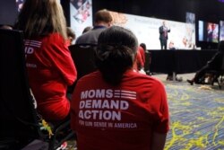 Audience members wearing "Moms Demand Action" gun reform T-shirts listen to Democratic presidential candidate Sen. Michael Bennet speak at the Presidential Gun Sense Forum, Aug. 10, 2019, in Des Moines, Iowa.