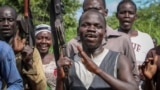 n this Wednesday, Aug. 28, 2019 file photo, opposition soldiers chant "Viva IO", meaning "long live the opposition", during a visit by a ceasefire monitoring team, at an opposition military camp in Eastern Equatoria state, South Sudan.