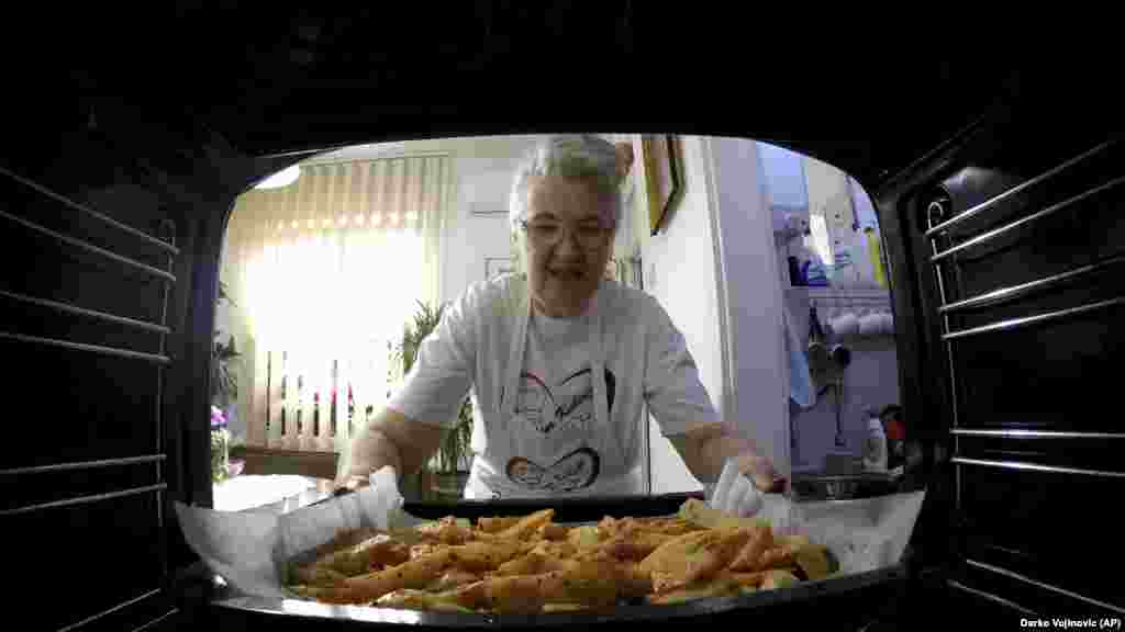 Serbia Granny's Kitchen: Jelena Petrovic places the tray with food into the oven
