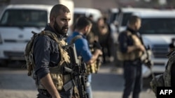 Members of the Kurdish-led Syrian Democratic Forces (SDF) are pictured during preparations to join the front against Turkish forces, near the northern Syrian town of Hasakeh, Oct. 10, 2019.