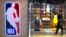 一名男子从北京一家NBA专卖店走出。（2019年10月8日）